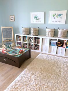 a living room with bookshelves and toys on the floor in front of it