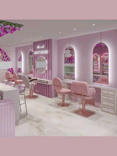 the interior of a salon with pink chairs and mirrors