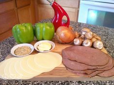 a cutting board topped with sliced up meat and veggies next to an oven