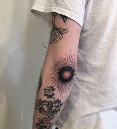 a person with a tattoo on their arm and the sun in the middle of his arm