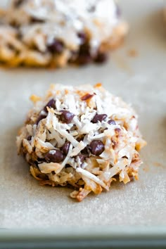 cookies with coconut and chocolate chips on a baking sheet, ready to be baked in the oven