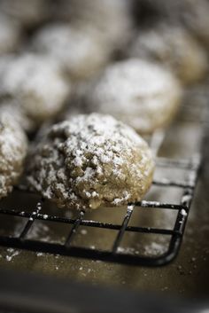 powdered sugar cookies cooling on a wire rack