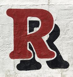 the letter r is painted in black and red