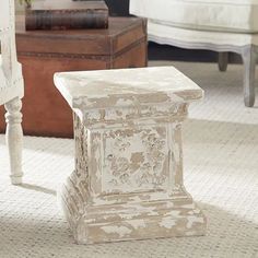 a white bench sitting on top of a rug in a living room next to a chair