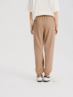 Details: Khaki color casual pants Made of high-count combed cotton, soft and comfortable to the touch Elastic waist, easy to put on and take off Customized embroidery, drawstring leg Materials & Care: Cotton 80.2%, Polyester 19.8% Hand wash | Dry clean Do not bleach Size & Fit: Model is 5'7", Bust 32, Waist 24, Hips 35, wearing a size S Item #: WM2PA07 Casual Relaxed Fit Neutral Pants, Leisure Brown Cotton Pants, Comfortable Leisure Brown Bottoms, Comfortable Brown Leisure Bottoms, Comfortable Brown Relaxed Fit Sweatpants, Casual Brown Pants For Leisure, Casual Neutral Bottoms With Elastic Waistband, Casual Brown Leisure Pants, Brown Leisure Pants With Elastic Waistband