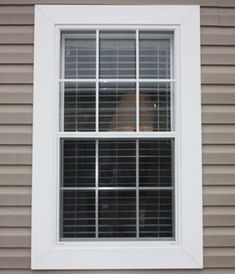 a person is looking out the window with their head in the window sill,