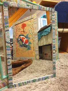 a mirror that is on the floor in front of a carpeted area with a dog house