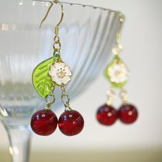 Cherish someone you love, sweet love, pretty girl and vitality are the symbolic meanings of the cherry. Purity and peace are the meanings of this little white flower. These cherry earrings bring sincere blessings to you, either for your own use or as a gift for someone you love. May these earrings brighten up your life. 🙂 All my jewellery is designed and handmade at home. Handmade with love.  🙂 Introducing our stunning handmade earrings, this pair is made from glass cherry, 925 anti-allergy si Cherry Colored Jewelry For Valentine's Day Party, Cherry Jewelry For Valentine's Day Party, Cherry-colored Jewelry For Valentine's Day Party, Cherry Color Jewelry For Valentine's Day Party, Sweet Red Jewelry For Valentine's Day, Cute Red Earrings For Christmas, Retro Earrings For Valentine's Day Gift, Cute Red Christmas Earrings, Cherry Dangle Earrings For Party