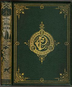 a green book with gold lettering on the front and back cover, in an ornate frame