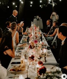 a group of people sitting around a dinner table