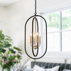 a chandelier hanging from the ceiling in a living room