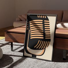 a black and gold microphone sitting on top of a wooden table next to a couch