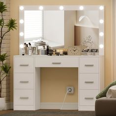 a white vanity with lights on it in a room