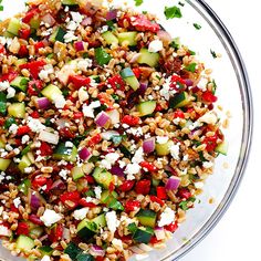 a glass bowl filled with lots of different types of food on top of a table