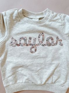 Cute Cotton Tops With Embroidered Text, Long Sleeve Tops With Letter Embroidery For Birthday, Embroidered Cotton Top For Birthday, Cute Crew Neck Tops With Custom Embroidery, Custom Embroidery Crew Neck Top For Birthday, Embroidered Applique Sweatshirt, Embroidered Crew Neck Top For Birthday, Custom Embroidered Crew Neck Top For Birthday, Embroidered Name Shirt