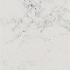 a white marble textured surface with black dots