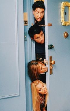 the cast of friends hanging out in front of an open door with their heads sticking out