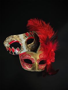 Couple's elegant Venetian masquerade mask set in red and gold. Adorned with red lush feathers, the women's mask exudes a sense of opulence that will leave admirers enchanted. The men's half-face phantom mask captures the essence of mystery and intrigue. The matching set ensures you and your partner complement each other beautifully, making the night extra special.   Age Group/Gender - Adult/Unisex  Size/Type - One size fits all adults  Mask Color - Red/Gold  Mask Material - Polyresin  Accent Mat Red Mask Masquerade, Red Masquerade, Kids Party Packs, Phantom Mask, Couples Masquerade Masks, Masquerade Theme, Venetian Masquerade Masks, Red Mask, Female Mask