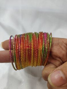 Welcome to our shop We bring to you very ethnic products from core of India almost every thing is handmade or custom made Set of 22 Bangles in multiple colors Size 2.4 We will be happy to serve you Multicolor Round Bangle For Party, Multicolor Party Bangle, Traditional Multicolor Bangle With Round Beads, Adjustable Multicolor Bangle With Round Beads, Multicolor Festival Bangle Bracelet, Adjustable Multicolor Bangle, Adjustable Multicolor Beaded Bangle, Bohemian Multicolor Round Bangle, Multicolor Round Beads Bangle For Festival