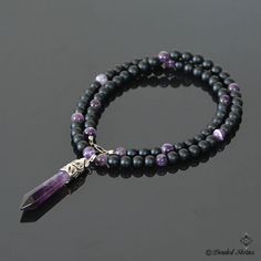 The centerpiece of this long gemstone men's necklace is an Amethyst healing point pendant. The combination of black matte onyx and shiny purple striped amethyst beads creates balanced, manly and sophisticated look. This piece is perfect for making a statement effortlessly and stylishly. This necklace is strung on a beaded wire and finished off with a lobster claw clasp. You can select the necklace length from the drop-down menu on the right. The pendant measures approximately 2.36 inches long (6 Amethyst Healing, Healing Crystal Jewelry, Personalized Pendant, Amethyst Beads, Men's Necklace, Amethyst Necklace, Men Necklace, Gemstone Necklace, Crystal Jewelry