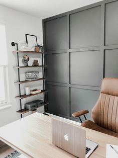 an office with a chair, desk and laptop computer on the table in front of it