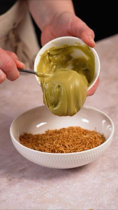 a person is dipping something into a bowl