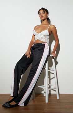 Get a sporty, relaxed look with the Ties Track Pants from LA Hearts. Featuring an elastic waistband for a comfortable fit, these pants are detailed with playful bow ties at the hips and bold contrast side stripes. The side hand pockets add practicality, while the wide leg openings and baggy fit ensure a laid-back, stylish vibe.11" rise31.5" inseam20" leg openingSit low on the waistElastic waistbandSide stripe detailsSide hand pocketsBow ties at hipsWide leg openingsBaggy relaxed fitSelf/Contrast: 100% polyesterHand washModel is wearing a size smallModel measurements: 5’10” height, 32” bust, 24” waist, 35” hipsMeasurements taken from a size small LA Hearts Womens Ties Track Pants - Black/white size Small White Sporty Parachute Pants For Loungewear, Sporty White Parachute Pants For Loungewear, White Parachute Pants With Elastic Waistband For Loungewear, White High-waisted Sporty Sweatpants, Sporty White Wide Leg Parachute Pants, Sporty White Wide-leg Parachute Pants, White Sporty Parachute Pants With Elastic Waistband, White Fitted Pants With Drawstring, Fitted White Pants With Drawstring