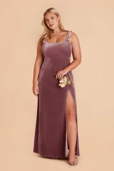 a woman in a long purple dress with a slit down the side and one leg