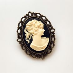 "Cameo Brooch Vintage Lady Pin Brooch Bouquet Victorian Costume Cameo Jewelry -I make this brooch using a black and cream cameo and set it in an antique brass setting -Nickel free lead free alloy metal, resin cameo, C clasp closure -Measures 1 1/4\" x 1 1/2\" -Gift Boxed More of my Cameo Jewelry: https://www.etsy.com/shop/lydiasvintage?search_query=cameo More of my Brooches: https://www.etsy.com/shop/lydiasvintage?ref=seller-platform-mcnav&section_id=6786664" Camphor Glass Jewelry, Victorian Costume, Gothic Victorian, Cameo Jewelry, Brooch Bouquet, Vintage Lady, Victorian Lady, Vintage Cameo, Antique Brooches