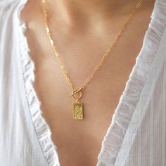 A gold rectangular medallion depicting Saint Christopher on a dainty chain with a toggle clasp. The modeling photo shows the 18 in. necklace length version. The Herkimer Diamond necklace also available here: https://www.etsy.com/listing/719636705/herkimer-diamond-necklace-herkimer MEASUREMENTS AND Gold Necklace Square Pendant, Gold Medallion Necklace, St Christopher Necklace, Herkimer Diamond Necklace, St Christopher, Heavy Chain, Gold Medallion, Toggle Necklace, Saint Christopher