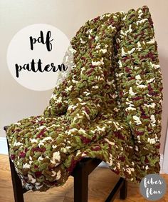 a crocheted blanket sitting on top of a wooden chair