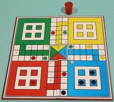 a game board with several different colored squares and numbers on the top, including one red dot