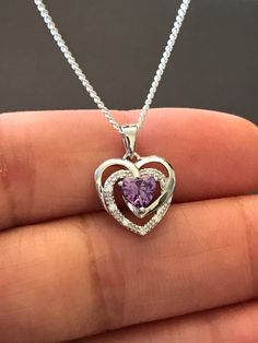 "Sterling Silver Amethyst CZ Heart Necklace Metal: All components are made from solid .925 Sterling Silver Stone: Cubic Zirconia Measurement: pendant is 17mm (0.67\")long including bail and 12mm (0.47\") wide Choose Chain Length Please feel free to Convo me with any questions before purchasing. Please view policy before purchasing You can find other CZ and Birthstone Jewelry in my shop here https://www.etsy.com/shop/LinksAndStones?ref=seller-platform-mcnav&section_id=24399452 Thank You For V Sterling Silver Heart Birthstone Necklace, Purple Double Heart Jewelry For Valentine's Day, Valentine's Day Amethyst Heart Necklace, Sterling Silver Heart Pendant Birthstone Necklace, Sterling Silver Birthstone Necklace With Heart Pendant, Heart-shaped Sterling Silver Birthstone Necklace As Gift For Her, Sterling Silver Open Heart Birthstone Necklace, Purple Heart Necklace For Valentine's Day Anniversary, Silver Sterling Birthstone Necklace With Heart Cut