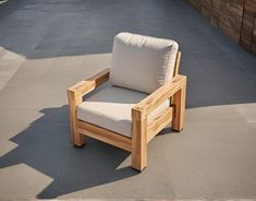 a wooden chair sitting on top of a cement floor