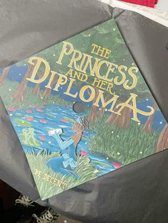 the princess and the frog book is on top of a graduation cap that reads,'the princess and her diploma '