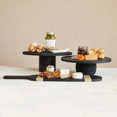 two black serving trays with food on them