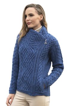 a woman wearing a blue cable knit sweater