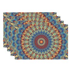 three placemats with an intricate design on them, each featuring different colors and shapes