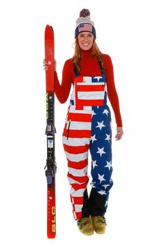 a woman in an american flag outfit holding skis