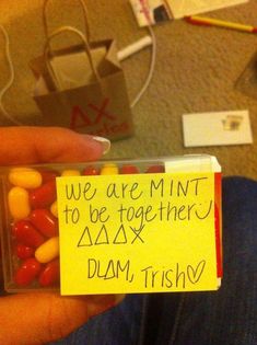 a person holding a candy bar in their hand with a note attached to it that says we are mintt to be together