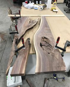 two wooden benches sitting next to each other on top of a table