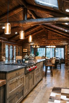 a large kitchen with wooden walls and flooring