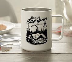 a camper mug sitting on top of a wooden table