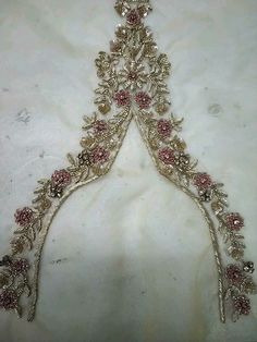 an elaborately designed tiara is displayed on a white cloth