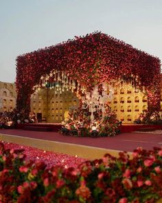 an elaborately decorated building with flowers in the foreground