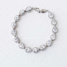 There is stunning style in this CZ bracelet! Created with pear cut stones in a pave setting, it is a radiant style and will add a touch of class to any wedding ensemble. It is 7.5 or 7 inches long and 3/8 of an inch wide. Grade AAA CZ, rhodium, gold or rose gold plated and lead free. Beautiful Wedding Hair, Set Bracelet, Bridal Accessories Jewelry, Cz Bracelet, Stunning Style, Wedding Sale, Bridal Bracelet, Pave Setting, Wedding Jewelry Sets