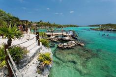 people are swimming in the clear blue water