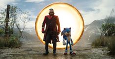 a man and woman standing in front of a giant ball with sonic the hedge on it