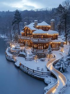 a large house is lit up in the snow with lights on it's roof