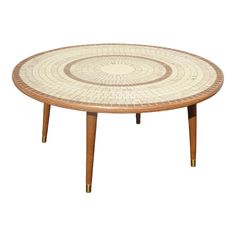 a round table with wooden legs and a mosaic design on the top